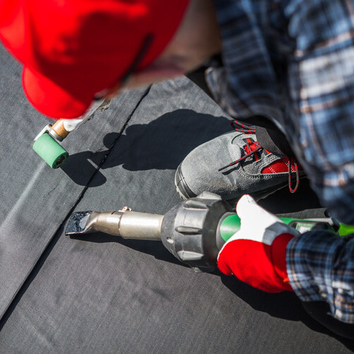 EPDM roofing being applied